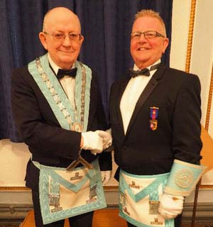John Davies (left) is congratulated by his predecessor Ted Eaves. John Davies (left) is congratulated by his predecessor Ted Eaves.