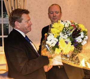 Mark Pedder (right) presents a bouquet to Kevin Poynton for his wife Susan. Mark Pedder (right) presents a bouquet to Kevin Poynton for his wife Susan.