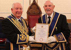 Harry Cox (left) presents Trevor Molloy with his 50 years’ service certificate. Harry Cox (left) presents Trevor Molloy with his 50 years’ service certificate.