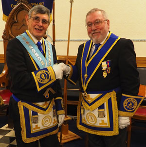 Bob Taylor (left) hands over to installing master Derek Lewthwaite. Bob Taylor (left) hands over to installing master Derek Lewthwaite.