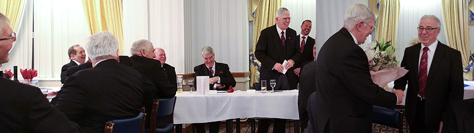 Picture left: Tony Harrison shares a joke with the brethren. Picture right: Colin Goodwin presenting flowers to Tony to take home to Maureen as thanks for allowing him to come for a ‘Grand Day’ out to Blackpool.