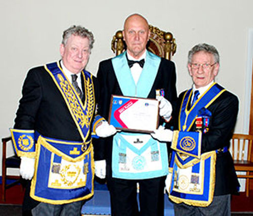 Ian Gee (left) presents Peter Scott with the MCF 2021 Festival Patron certificate, with Malcolm Sandywell (right) watching.