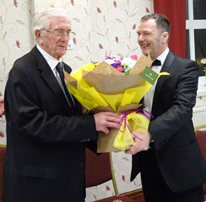 Norman Gregson (left) receives flowers for Margaret from Jamie Blundell.