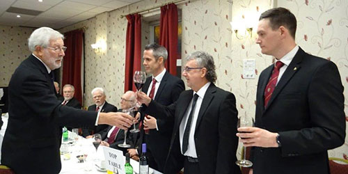 John Chesters (left) toasts Hugh Mett during the principal’s song John Chesters (left) toasts Hugh Mett during the principal’s song
