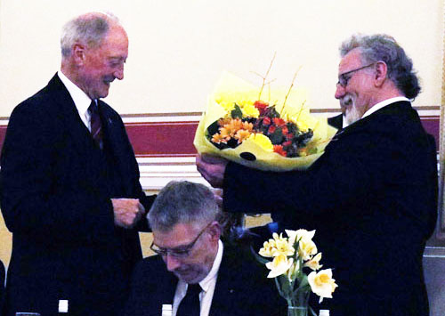 Chris presents Barry with flowers and good wishes. Chris presents Barry with flowers and good wishes.