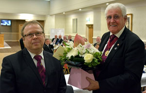 Jayson (left) presents Malcolm with a floral gift. Jayson (left) presents Malcolm with a floral gift.