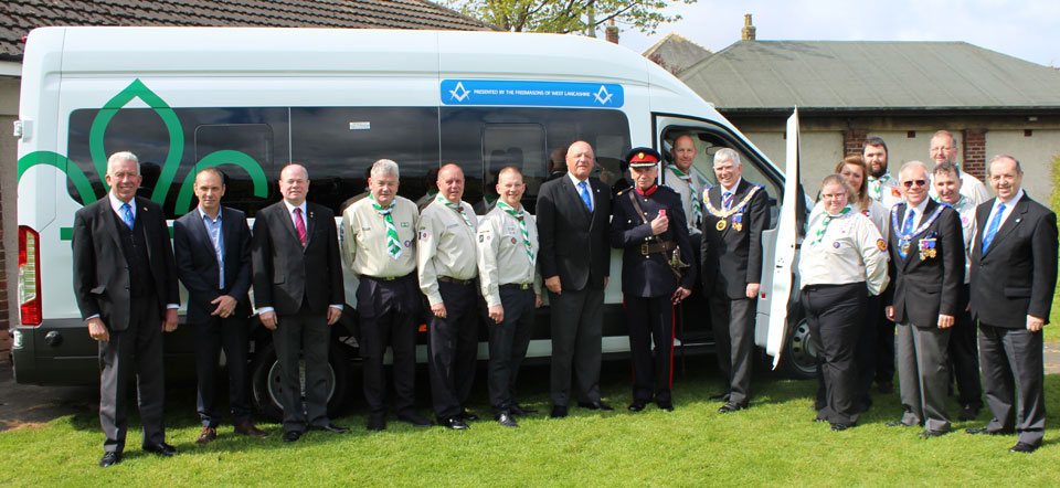 Tony Harrison is pictured with George Binns (driving seat), John Barnett MBE, scout leaders and Freemasons. Tony Harrison is pictured with George Binns (driving seat), John Barnett MBE, scout leaders and Freemasons.