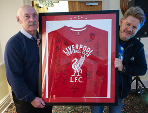 Jim Corcoran (left) presents Mikey Powell with his auction prize. Jim Corcoran (left) presents Mikey Powell with his auction prize.