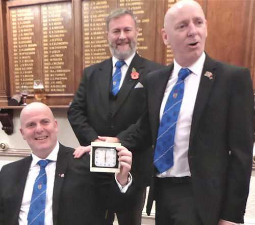 Alan Routledge (left) receives the clock from Ian McGovern Alan Routledge (left) receives the clock from Ian McGovern