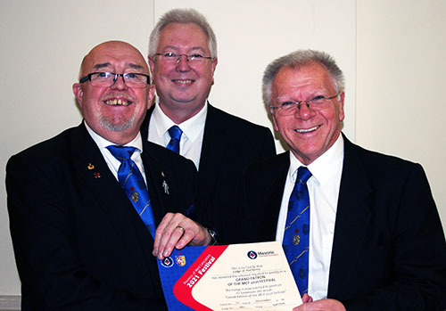 Derek (right) presents Barry with the Grand Patron’s Certificate with John Murphy looking on. Derek (right) presents Barry with the Grand Patron’s Certificate with John Murphy looking on.