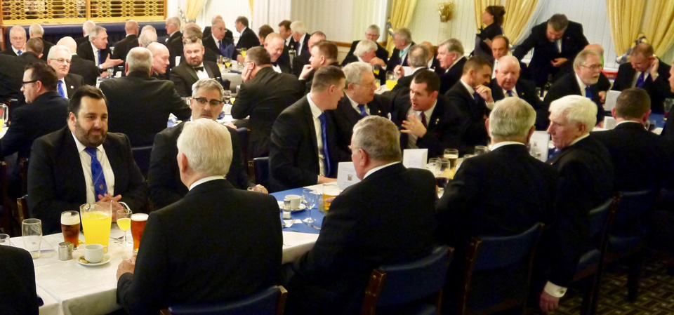 Brethren enjoying the festive board and jugs of orange juice. Brethren enjoying the festive board and jugs of orange juice.