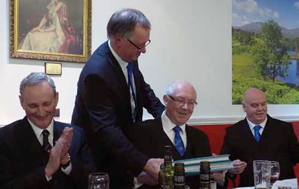John Robbie Porter (standing) presents Mike Heed with his memento folders. John Robbie Porter (standing) presents Mike Heed with his memento folders.