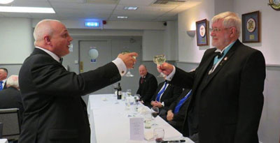 John Darrell (left) toasting Brian Crawford during the master’s song. John Darrell (left) toasting Brian Crawford during the master’s song.