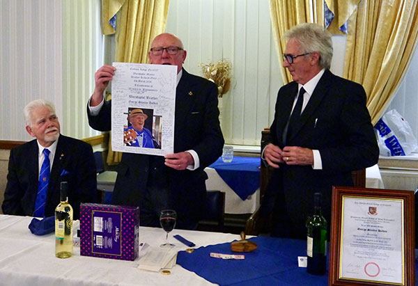 Pictured from left to right, are: David Randerson, George Holden (with a poster signed by the guests) and Richard Olley. Pictured from left to right, are: David Randerson, George Holden (with a poster signed by the guests) and Richard Olley.