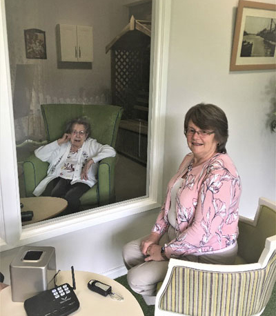 Ecclesholme resident, Olive Marshall, is reunited with her daughter, Susan Rees, in the home’s new visitor pod.