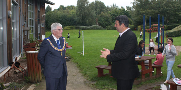 Dave (right) explaining the facilities as children enjoy the play area. Dave (right) explaining the facilities as children enjoy the play area.