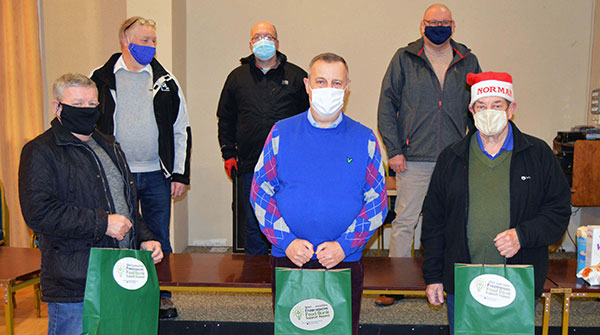 Peter Lockett (centre) with one of the 100s of 'West Lancashire Freemason Food Bank Appeal' carrier bags, also donated to the foodbank. Peter Lockett (centre) with one of the 100s of 'West Lancashire Freemason Food Bank Appeal' carrier bags, also donated to the foodbank.