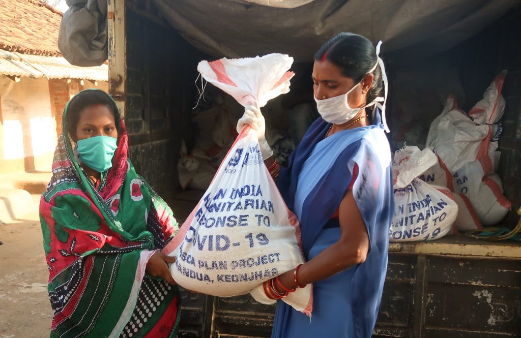 Women receive food kits in India.