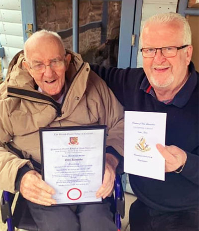 Neil (left) receiving his certificate from his son-in-law Mark Connell.