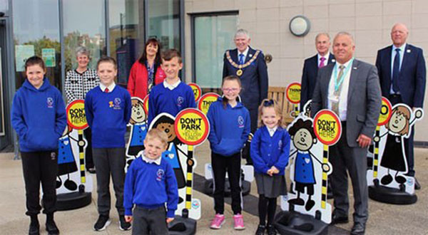 Pictured from left to right, behind the pupils, are: Maureen Harrison, Sue Robinson (Headteacher), Tony Harrison, Howard Lloyd, John Topping and Steve Kayne, along with school pupils from the Blackpool Gateway Academy with the ‘School Buddy’ signs.