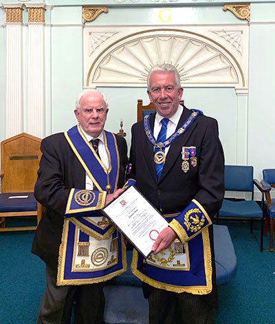 Tom Wood (left) receives his 50-year certificate from Mark Matthews
