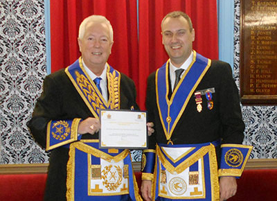 John Murphy (left) presenting the certificate of commendation to Gary Jones.