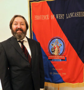 Terry Stevens-Lewing beside the new banner. Terry Stevens-Lewing beside the new banner.