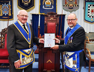 Ron Senior (left) is presented with his 50-year certificate from John Cross.