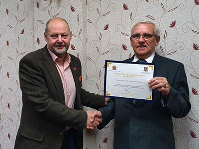 John Cross (left) presents Mike Winrow with his certificate. John Cross (left) presents Mike Winrow with his certificate.