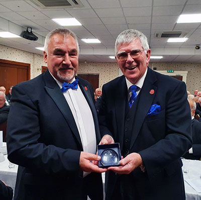 Martin Clements (left) presents Tony with a commemorative paper weight.