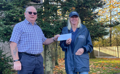 Cliff Jones (left) presenting the Bellisama Chapter cheque to Maggie.