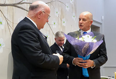 Stephen Walls (left) receives flowers from the WM.