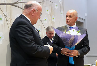 Stephen Walls (left) receives flowers from the WM. Stephen Walls (left) receives flowers from the WM.