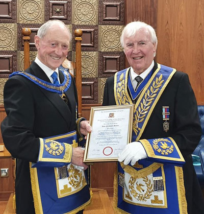 Barry Jameson (left) presents John Hutton with his 50-year certificate.