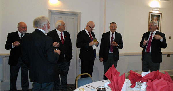 Paul Renton (right) with other guests having refreshments before the festive board.