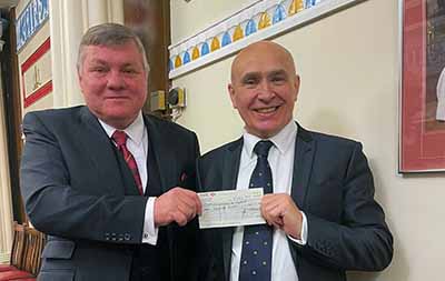 David Sampson for the Merseyside and Cheshire Blood Bikes (left) receives a cheque for £1,000 from Bob Martin.