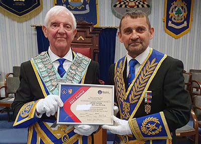 David Thomas (right) presenting Chris Williams with a Grand Patrons certificate