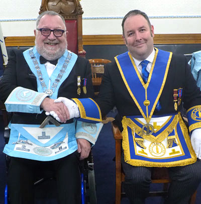 Roy Sibley (left) welcomes Ben Gorry into the lodge room. Roy Sibley (left) welcomes Ben Gorry into the lodge room.