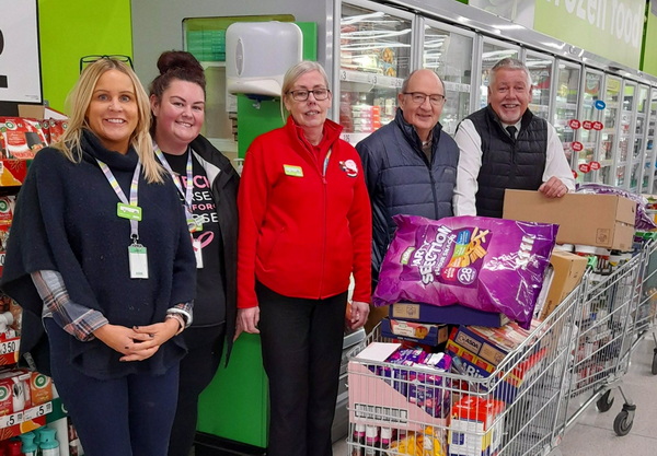 Asda Store Manager Ruth Houghton and her team help John Gibbon (second right) and Bob Williams do the shopping.