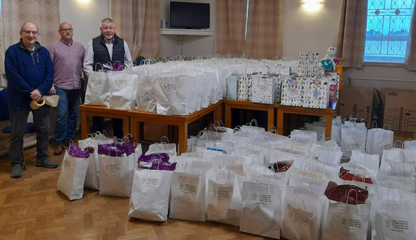 Pictured from left to right, are: John Gibbon, Ian Lynch and Bob Williams with gift bags and food parcels ready for loading. Pictured from left to right, are: John Gibbon, Ian Lynch and Bob Williams with gift bags and food parcels ready for loading.