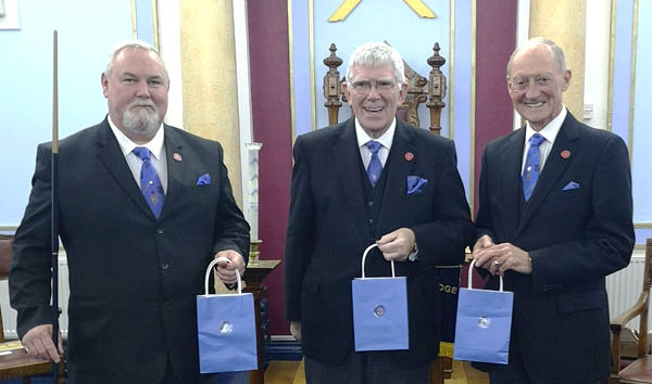 A traditional gift of the famous Eccles cakes at the Elm Bank celebration. Pictured from left to right, are: Gary Smith, Tony Harrison, and Barry Jameson.
