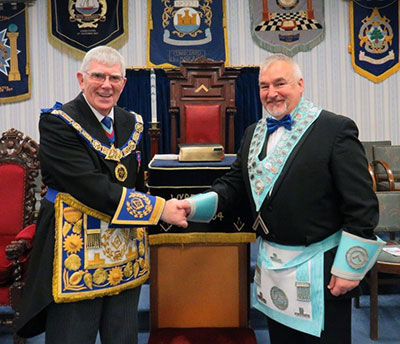 At the installation meeting at Wyre Lodge, Tony congratulates the new master, Martin Clements.