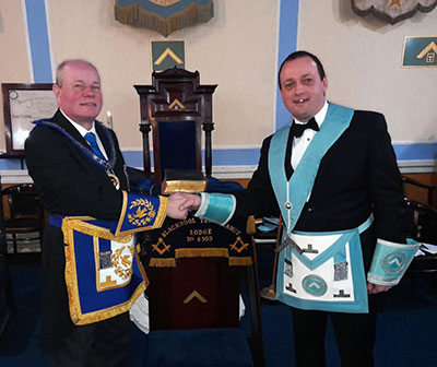 Duncan Smith (left) congratulates Tom Cunningham on becoming the new master. Duncan Smith (left) congratulates Tom Cunningham on becoming the new master.