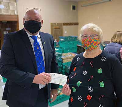 Group vice chairman Dave Bishop presenting a cheque to Celia Neill at the Leyland Food Bank.