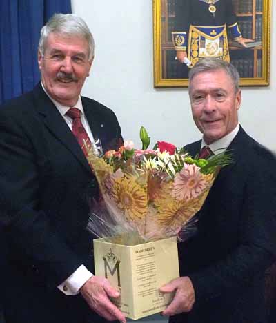 Paul Renton (left) receiving flowers for his wife from Clive Tandy.