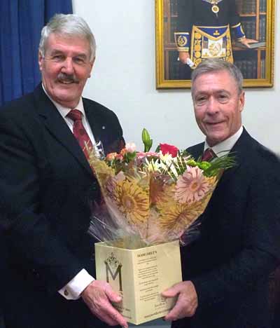 Paul Renton (left) receiving flowers for his wife from Clive Tandy. Paul Renton (left) receiving flowers for his wife from Clive Tandy.