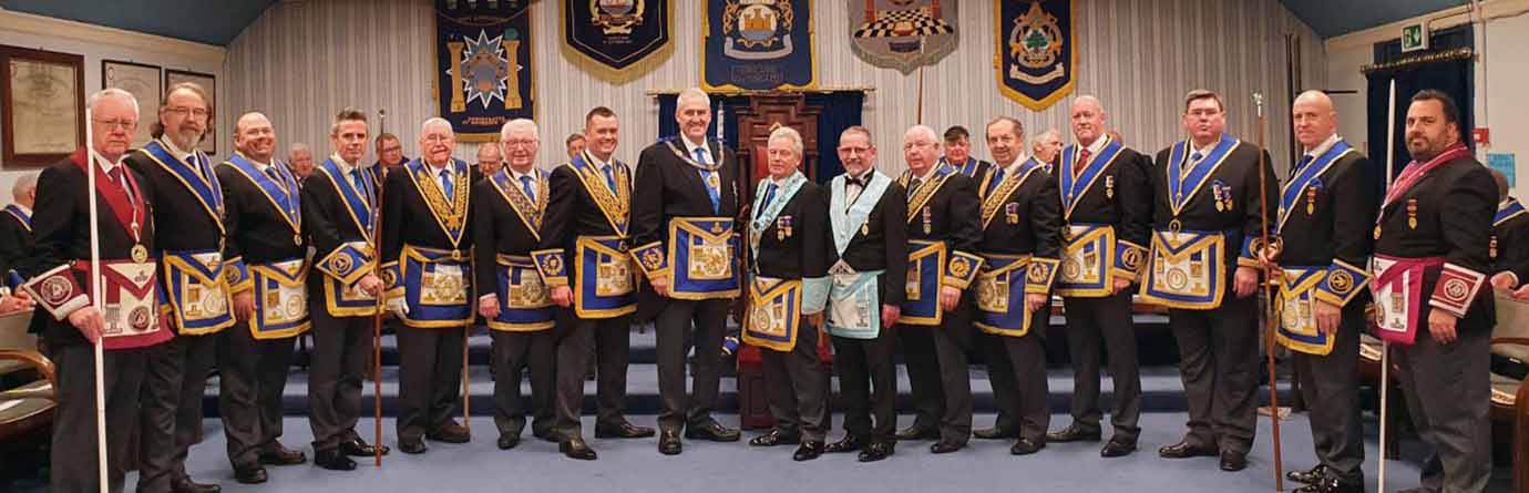 Andrew Whittle, Bob Bennett and Geoff Diggles surrounded by grand and acting Provincial grand officers.