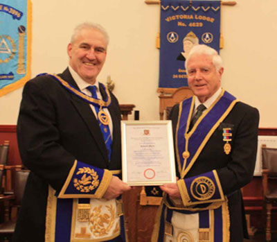Andrew (left) presents Ken with his certificate. Andrew (left) presents Ken with his certificate.