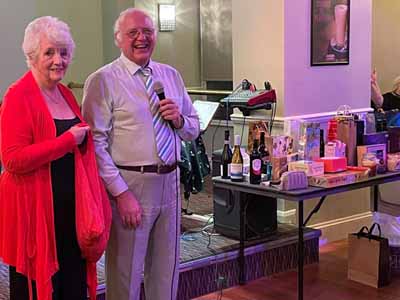 David and Joan draw the raffle. David and Joan draw the raffle.