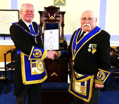 Duncan Smith (left) presents William Barrow with his 50 years in Freemasonry certificate.